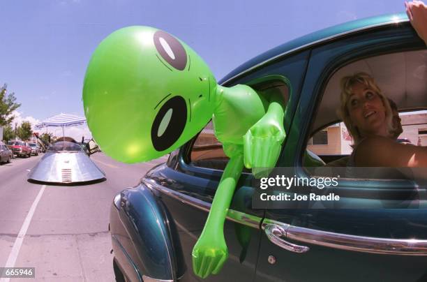 An alien doll hangs out a car window in downtown Roswell, New Mexico July 1, 2000 as part of the annual UFO Encounter, which runs through July 4,...