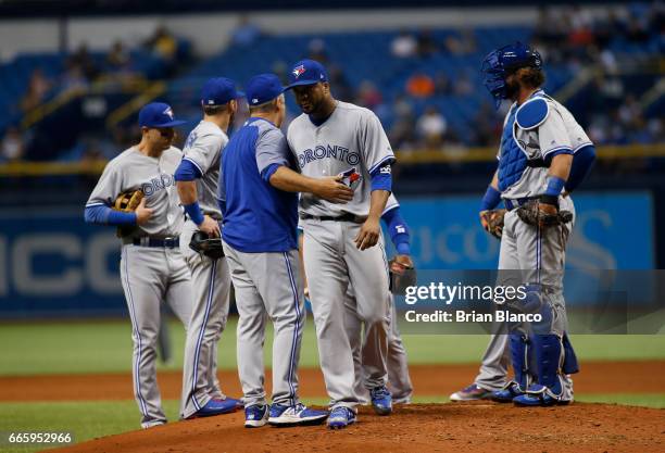 Francisco Liriano of the Toronto Blue Jays is taken off the mound by manager John Gibbons during the first inning of a game against the Tampa Bay...