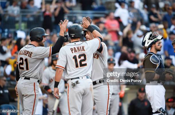 Brandon Belt of the San Francisco Giants, center, is congratulated, by Conor Gillaspie, and Joe Panik after hitting a Grand slam during the sixth...