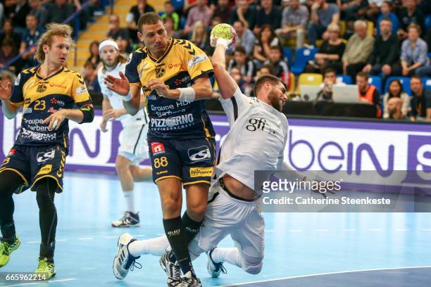 Luka Karabatic of Paris Saint Germain is shooting the ball against Wissem Hmam of Saint-Raphael Var Handball during the semi-final match of the Final...