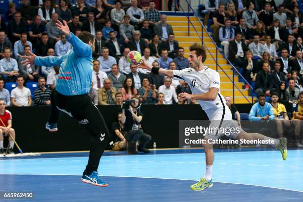 Uwe Gensheimer of Paris Saint Germain is shooting the ball against Slavisa Djukanovic of Saint-Raphael Var Handball during the semi-final match of...