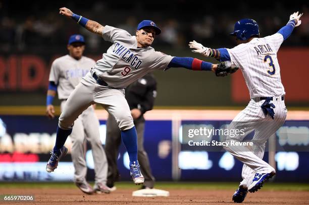 Javier Baez of the Chicago Cubs tries to tag Orlando Arcia of the Milwaukee Brewers during the fifth inning of a game at Miller Park on April 7, 2017...