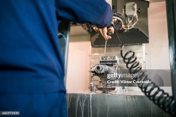 metal machining industry. worker operating cnc milling machine - milling cutter stock pictures, royalty-free photos & images