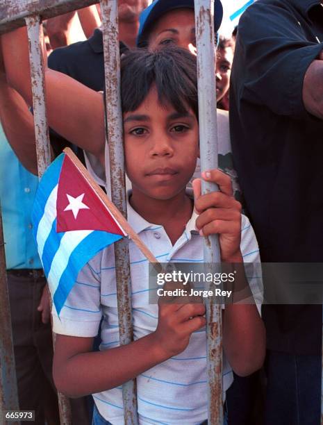 Eight years old, Rodriguez participates to a rally by holding a Cuban flag, July 1 in Manzanillo, 497 miles southeast of Havana. Fidel Castro's...