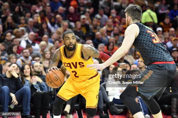 Kyrie Irving of the Cleveland Cavaliers drives around Ryan Kelly of the Atlanta Hawks during the first half at Quicken Loans Arena on April 7, 2017...