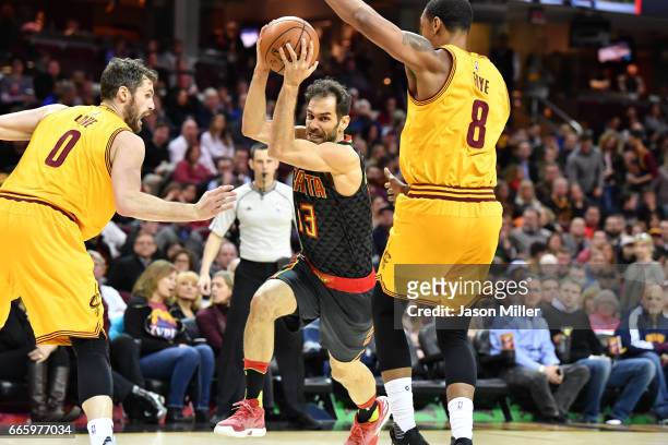 Kevin Love and Channing Frye of the Cleveland Cavaliers guard Jose Calderon of the Atlanta Hawks during the second half at Quicken Loans Arena on...