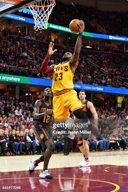 LeBron James of the Cleveland Cavaliers shoots over Taurean Prince of the Atlanta Hawks during the first half at Quicken Loans Arena on April 7, 2017...