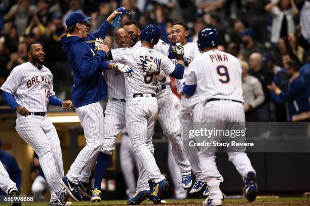 Ryan Braun of the Milwaukee Brewers celebrates with teammates after scoring the winning run on a passed ball during the eleventh inning of a game...