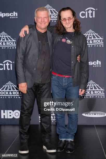 Presenters and 2013 Inductees Alex Lifeson and Geddy Lee of Rush attends the Press Room of the 32nd Annual Rock & Roll Hall Of Fame Induction...