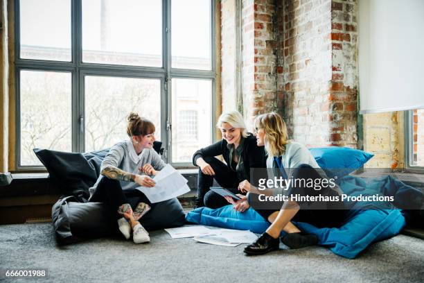 businesswomen talking during an informal meeting - new business stock pictures, royalty-free photos & images