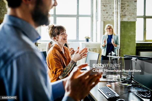 business people applauding to colleague in office - celebration stock-fotos und bilder