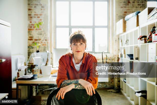 portrait of a casual dressed young businesswoman - office chair stock pictures, royalty-free photos & images