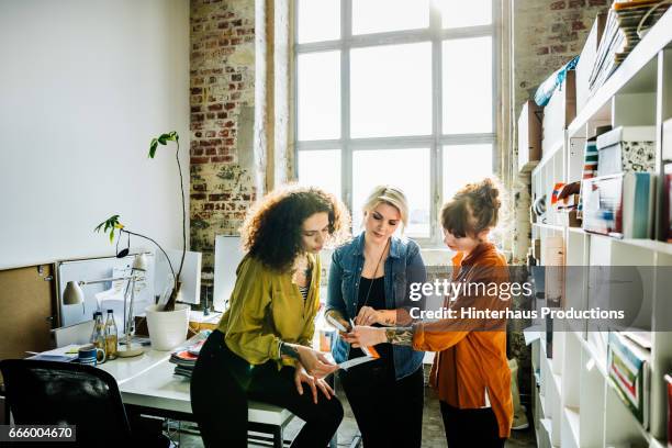 businesswomen having an informal meeting in a large office space - central europe stock pictures, royalty-free photos & images