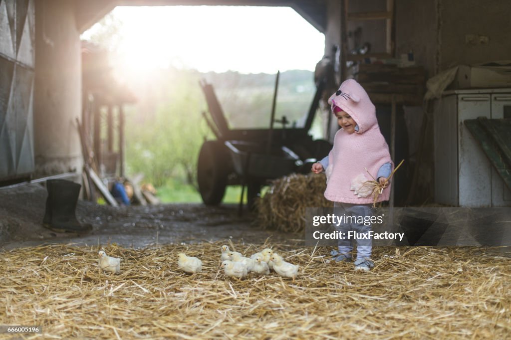 Farm girl with chickens smiling candid