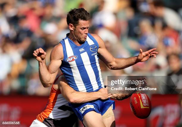 Sam Gibson of the Kangaroos is tackled by Devon Smith of the Giants during the round three AFL match between the North Melbourne Kangaroos and the...