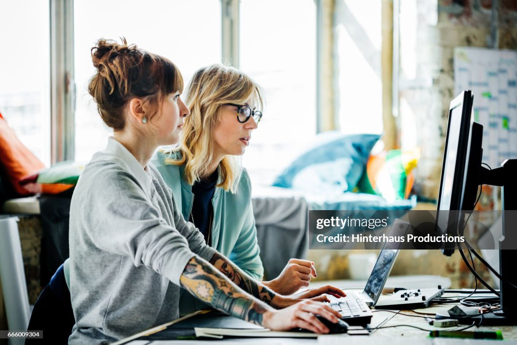 Two businesswomen working on a computer