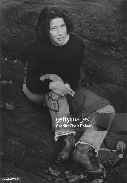 Portrait of American author Fran Lebowitz as she sits on a rock, New York, New York, 2010.