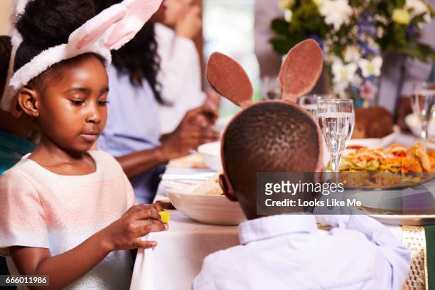 family and friends eating their easter meal. - easter sunday stock pictures, royalty-free photos & images