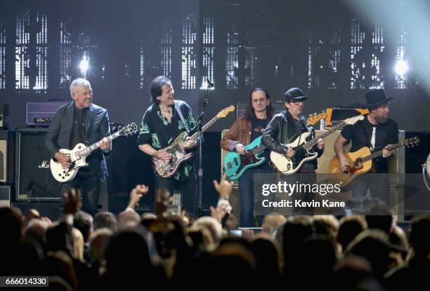 Inductees Alex Lifeson, Trevor Rabin, Mike McCready, Jeff Ament and presenter Dhani Harrison perform onstage at the 32nd Annual Rock & Roll Hall Of...