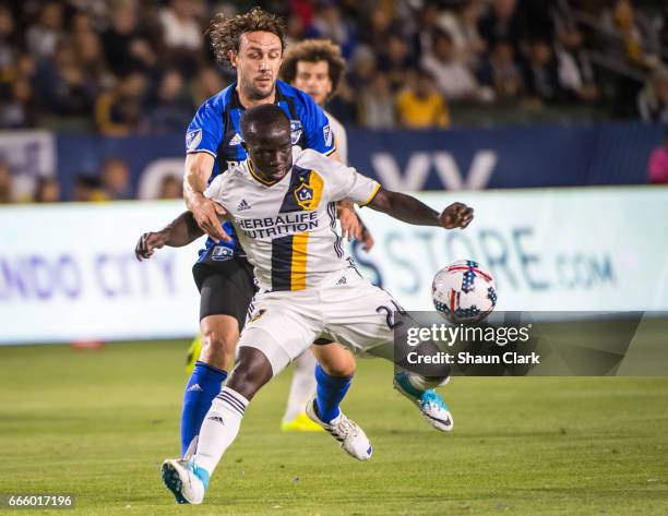 Ema Boateng of Los Angeles Galaxy battles Marco Donadel of Montreal Impact during Los Angeles Galaxy's MLS match against Montreal Impact at the...