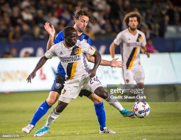 Ema Boateng of Los Angeles Galaxy battles Marco Donadel of Montreal Impact during Los Angeles Galaxy's MLS match against Montreal Impact at the...