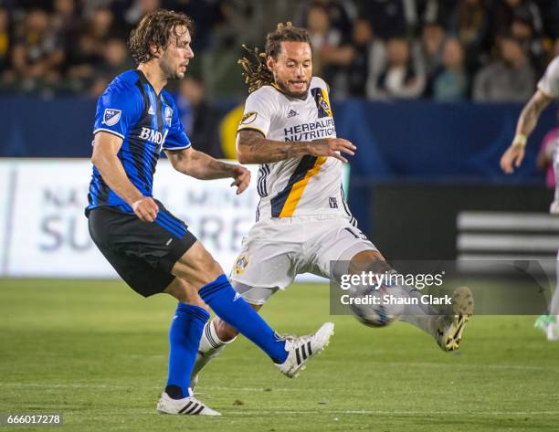 Marco Donadel of Montreal Impact passes the ball as Jermaine Jones of Los Angeles Galaxy defends during Los Angeles Galaxy's MLS match against...