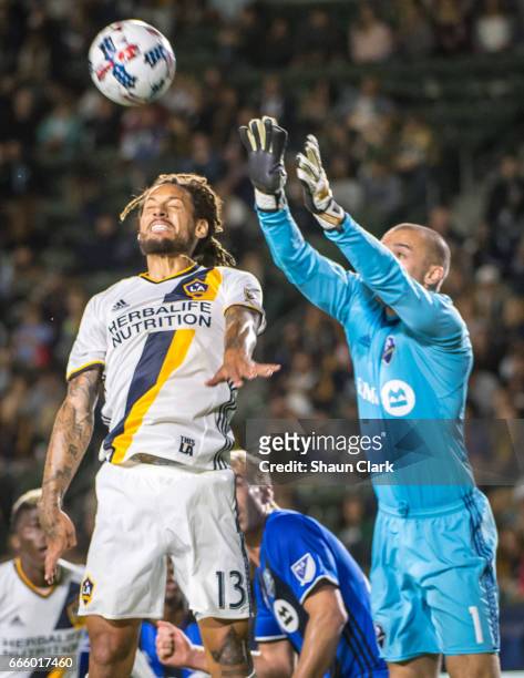 Evan Bush of Montreal Impact grabs the ball as Jermaine Jones of Los Angeles Galaxy tries to get on the end of a cross during Los Angeles Galaxy's...