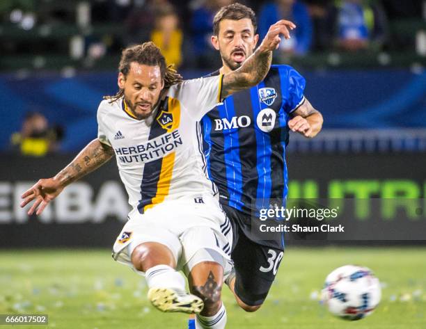 Jermaine Jones of Los Angeles Galaxy crosses the ball as Hernan Bernardello of Montreal Impact defends during Los Angeles Galaxy's MLS match against...