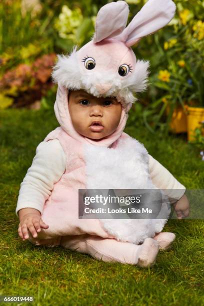 baby in an easter bunny outfit. - eastersowhite stock-fotos und bilder