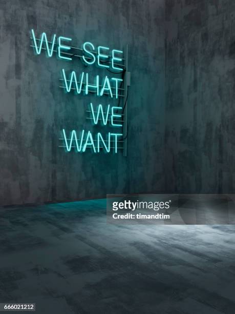 we see what we want neon in an empty room - text schriftsymbol stock-fotos und bilder