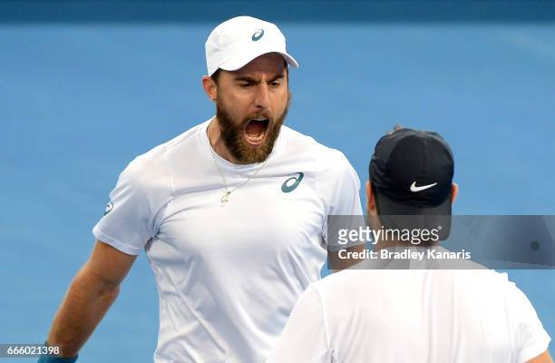 Steve Johnson of the USA celebrates victory with doubles team mate Jack Sock after defeating Sam Groth and John Peers of Australia in doubles during...