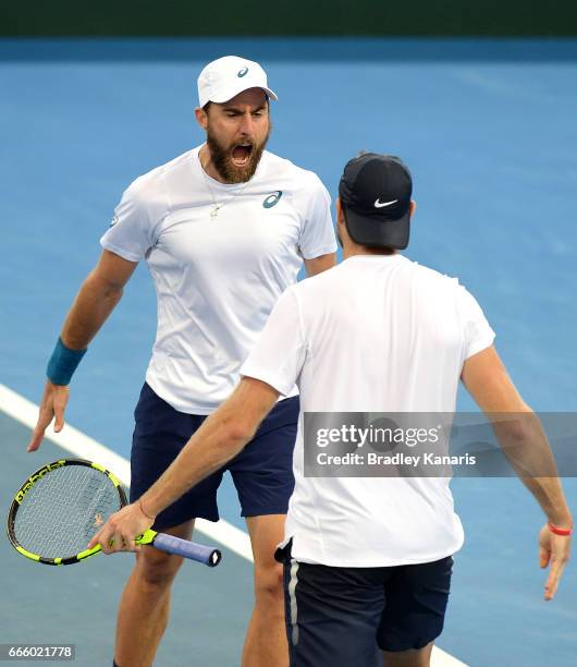 Steve Johnson of the USA celebrates victory with doubles team mate Jack Sock after defeating Sam Groth and John Peers of Australia in doubles during...