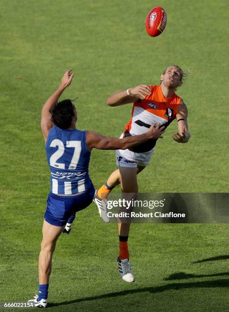 Nick Haynes of the Giants is challenged by Taylor Garner of the Kangaroos during the round three AFL match between the North Melbourne Kangaroos and...