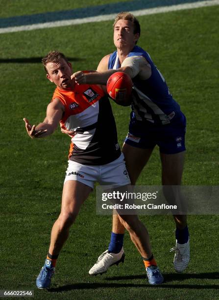 Steve Johnson of the Giants is challenged by Sam Durdin of the Kangaroos during the round three AFL match between the North Melbourne Kangaroos and...