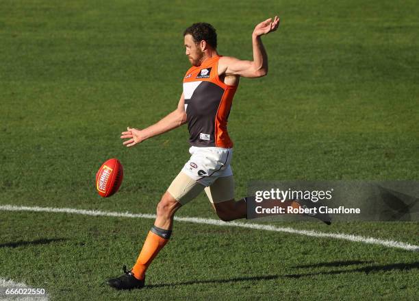 Shane Mumford of the Giants kicks the ball during the round three AFL match between the North Melbourne Kangaroos and the Greater Western Sydney...