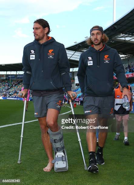 Ryan Griffen of the Giants walks off after the match after he was injured during the round three AFL match between the North Melbourne Kangaroos and...