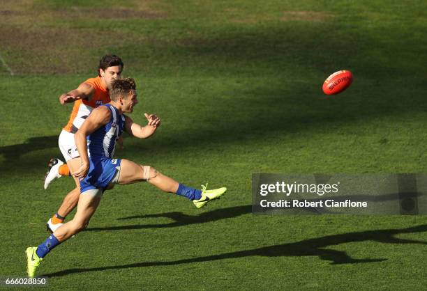 Shaun Higgins of the Kangaroos kicks upfield during the round three AFL match between the North Melbourne Kangaroos and the Greater Western Sydney...