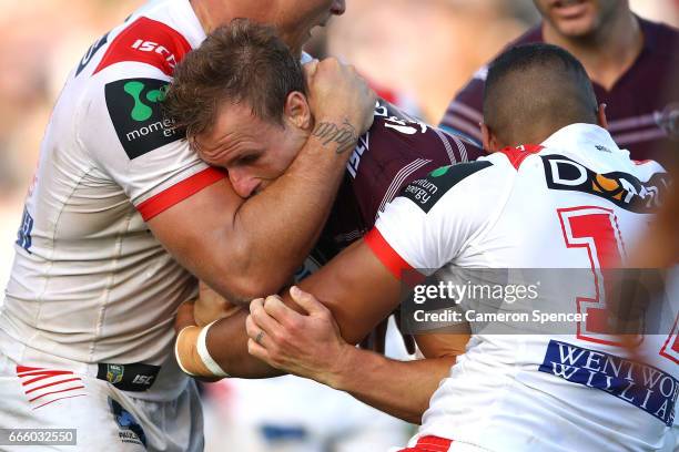 Daly Cherry-Evans of the Sea Eagles is tackled during the round six NRL match between the Manly Sea Eagles and the St George Illawarra Dragons at...