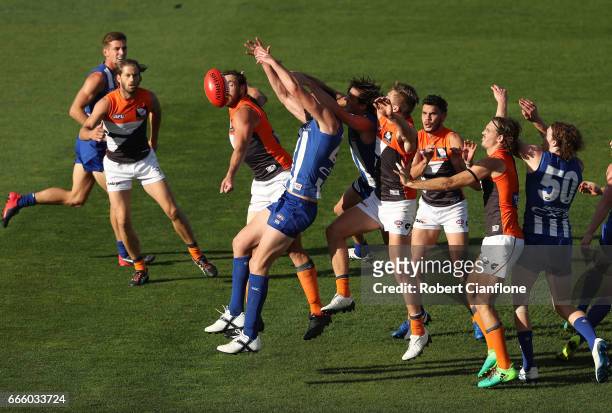 Players compete for the ball during the round three AFL match between the North Melbourne Kangaroos and the Greater Western Sydney Giants at...