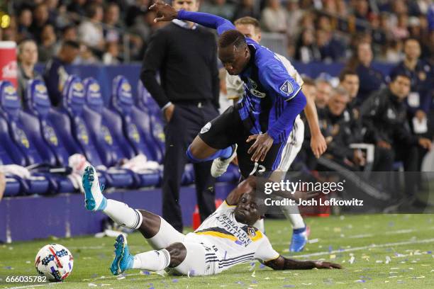 Ema Boateng slides into play against Ballou Jean-Yves Tabla of the Montreal Impact during the Los Angeles Galaxy's MLS match against the Montreal...
