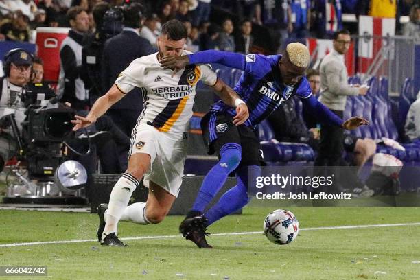 Romain Alessandrini of Los Angeles Galaxy and Ambroise Oyongo of Montreal Impact fight for possesion of the ball during Los Angeles Galaxy's MLS...