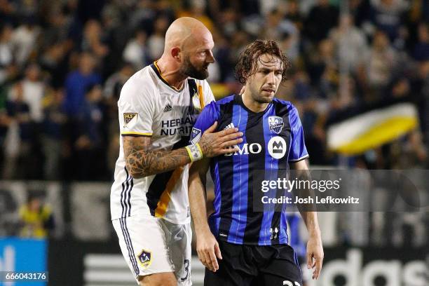 Jelle Van Damme of the Los Angeles Galaxy speaks to Marco Donadel of the Montreal Impact during the Los Angeles Galaxy's MLS match against Montreal...