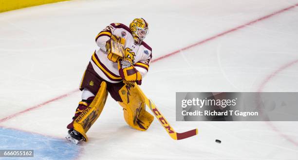 Hunter Miska of the Minnesota Duluth Bulldogs passes the puck against the Harvard Crimson during game one of the 2017 NCAA Division I Men's Hockey...