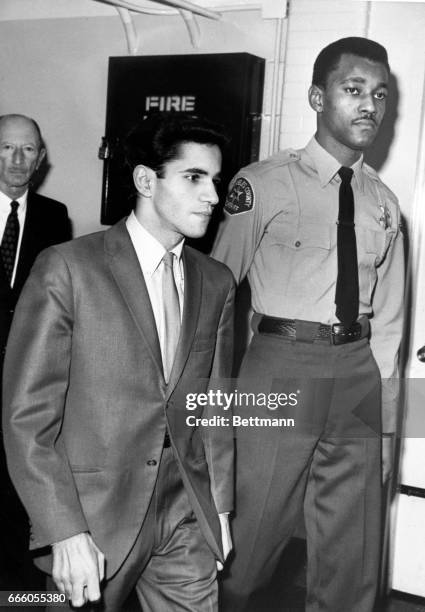 Sirhan Sirhan enters the courtroom accompanied by a deputy sheriff and followed by one of his attorneys, Emile Zola Berman.