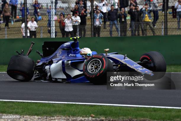 Antonio Giovinazzi of Italy driving the Sauber F1 Team Sauber C36 Ferrari sits in his car on track after crashing into a track barrier during...