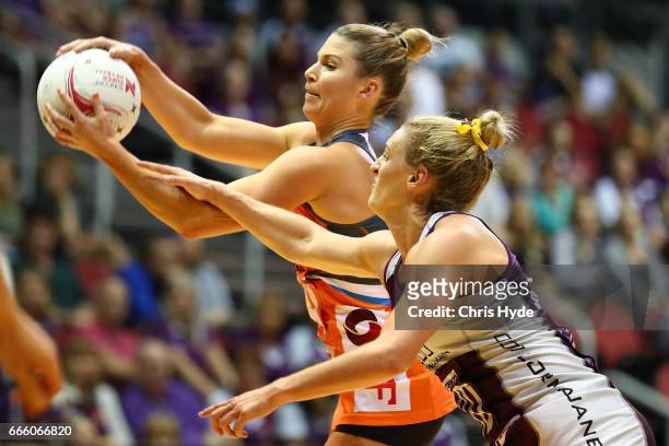 Taylah Davies of the Giants and Gabi Simpson of the Firebirds compete for the ball during the round eight Super Netball match between the Firebirds...