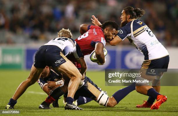 Samu Kerevi of the Reds is tackled during the round seven Super Rugby match between the Brumbies and the Reds at GIO Stadium on April 8, 2017 in...