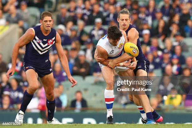 Nathan Fyfe of the Dockers tackles Tom Campbell of the Bulldogs during the round three AFL match between the Fremantle Dockers and the Western...