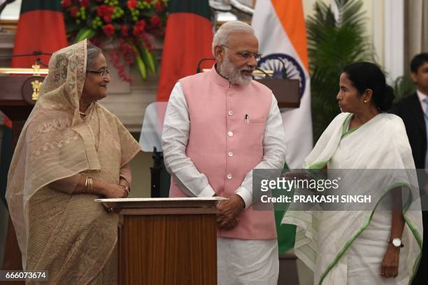 Indian Prime Minister Narendra Modi and Bangladesh Prime Minister Sheikh Hasina listens to West Bengal Chief Minister Mamta Banerjee during an...