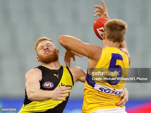 Nick Vlastuin of the Tigers and Brad Sheppard of the Eagles collide during the 2017 AFL round 03 match between the Richmond Tigers and the West Coast...